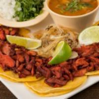 Tacos de Trompo · 5 small corn tortillas, marinated sliced pork, grilled onions and charros beans.