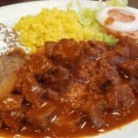 Asado de Puerco Plate · Red chili pork stew, rice, refried beans and flour or corn tortillas.