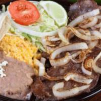 Bistec Encebollado Plate · Beef steak, grilled onions, rice, refried beans and flour or corn tortillas.