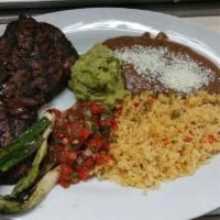 Carne Asada · Steak served with rice, beans, pico de gallo, guacamole and green onions. Includes 3 tortill...