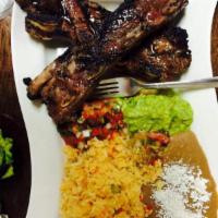 Costillas de Res Asadas · Grilled beef ribs, served with rice, beans, pico de gallo and guacamole. Specialties served ...