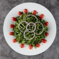 Baby Arugula Salad · Tomatoes, red onions, olive oil and lemon juice.