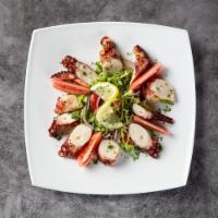 Octopus Salad · Char-grilled octopus served over lettuce, onion salad with balsamic vinegar and olive oil.