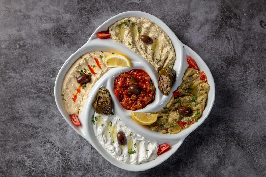 Mezze Platter · Combination of appetizers platter. Hummus, baba ganoush, lebni, spicy vegetable and eggplant with sauce.