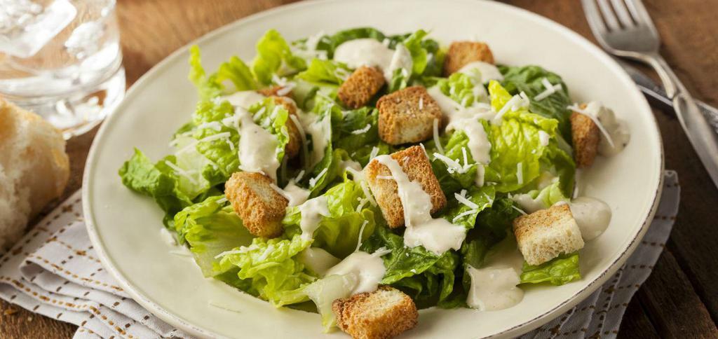 Caesar Salad · Tossed in classic Caesar salad dressing topped with croutons.