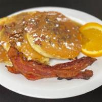 Bacon Praline Pancakes · Our classic buttermilk pancakes filled with applewood-smoked bacon and toasted pecans, toppe...