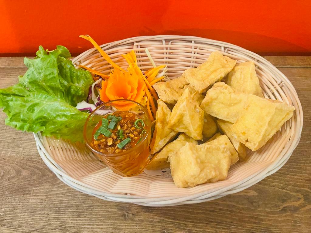 Crispy Tofu · Deep-fried fresh tofu with sweet and sour sauce topped with ground peanut and chopped onion. Gluten free.