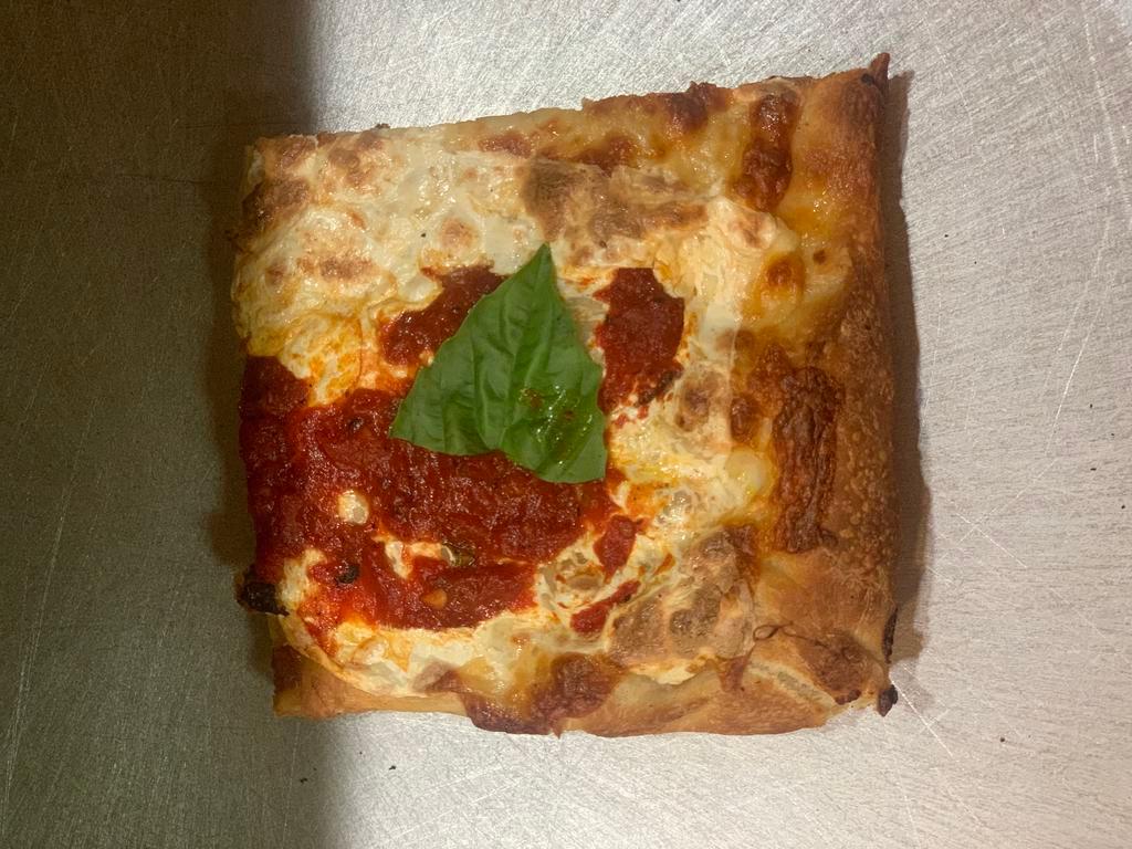 Grandma Pizza Slice · Marinara, fresh mozzarella and basil pie.