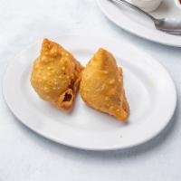 Vegetable Samosa ~ 2 pieces · Traditional triangular puffed pastry filled with potatoes, peas, carrots and mild spices and...