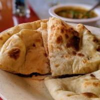Coconut Naan · Naan bread stuffed with coconut powder, with a touch of butter on top.