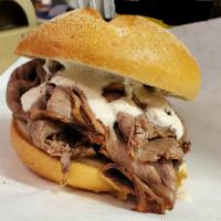Hot Roast beef · Oven roasted beef, sliced and drenched in au jus topped with provolone cheese and horseradis...
