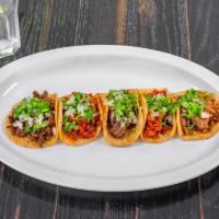 Handmade Tortilla Tacos · Our tacos come on a Hand-Made Tortilla and are topped with Traditional Cilantro and Onions. ...