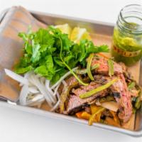 CARNE ASADA · Char-Grilled Flank Steak marinated in Soy Sauce + Morita Salsa and grilled. Served with char...