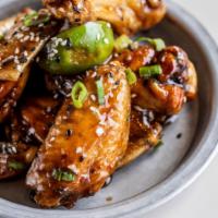 Tri-cooked Firecracker Wings  · Smoked. Fried. Tossed. 
Pecan smoked wings tossed in citrus firecracker sauce, garnished wit...