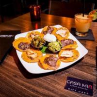 CM Nachos · Individually prepared crispy corn tortilla chips topped with melted cheese, beans, guacamole...