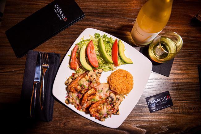 Pollo con Camarones · Grilled chicken breast served with three sautèed shrimp, pico de gallo and mushrooms, topped with melted jack cheese