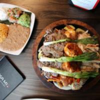 Sizzling Fajitas for Two · Sizzling Fajitas, served with Chicken and Skirt steak, Spanish rice, beans, guacamole and so...