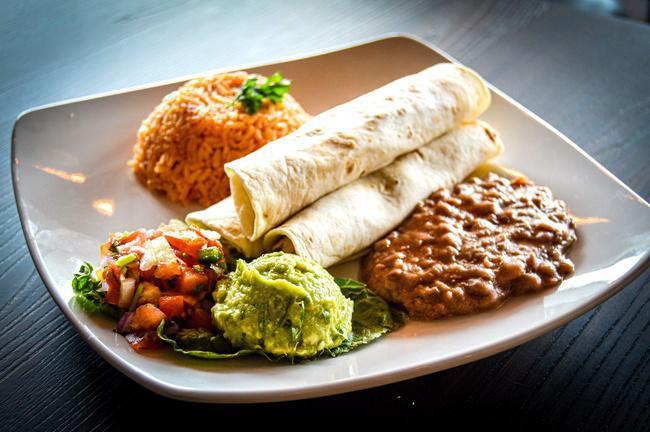 Tacos de Pollo · Three grilled chicken tacos served with spanish rice, beans guacamole and pico de gallo