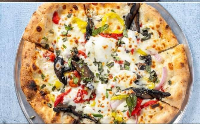 Veggie Pizza · White garlic sauce, banana peppers, red onions, potabellos, roasted red peppers, fresh basil, buffalo mozzarella and olive oil.