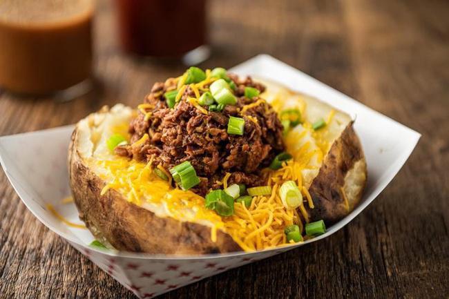CHOPPED BAKER · Baked Potato loaded with butter, sour cream, cheese and chives and a quarter pound of our chopped BBQ