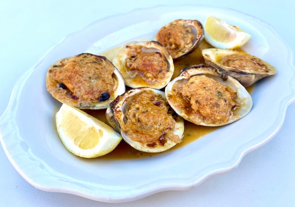 Baked Clams Oregnata · 6 top necks on the 1/2 shell, baked with garlic, lemon, olive oil, romano cheese and topped with seasoned Italian bread crumbs  