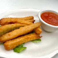 Zucchini Sticks · Breaded zucchini, fried golden brown and served 
with a side of marinara sauce 