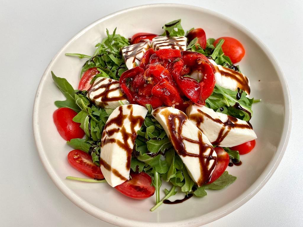 Arugula Salad · Housemade mozzarella, grape tomatoes, roasted red peppers, balsamic glaze 