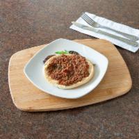 Lahm Bil-Ajin Pizza · Ground lamb, crushed tomato and spices.