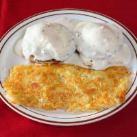 Country Eggs Benedict  · Two sausage patties atop warm buttermilk biscuits with two poached eggs, smothered in our si...