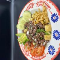 Ensalada Tapatia · House specialty. Grilled steak over a mix of chromaine, spinach, tomatoes, whole with black ...