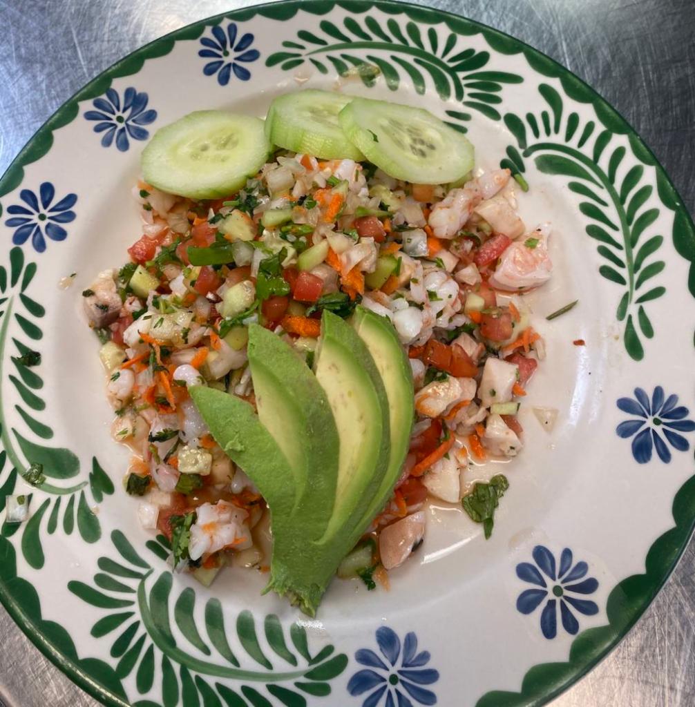 Ceviche · Your choice of shrimp or fish cooked with lime juice, cilantro, onions, tomatoes, carrots and cucumbers. Garnished with avocado and orange slices. Gluten free.