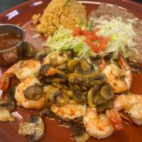 Camarones Al Mojo de Ajo · Large shrimp sauteed in garlic sauce, cooked with fresh mushrooms and served with rice and b...