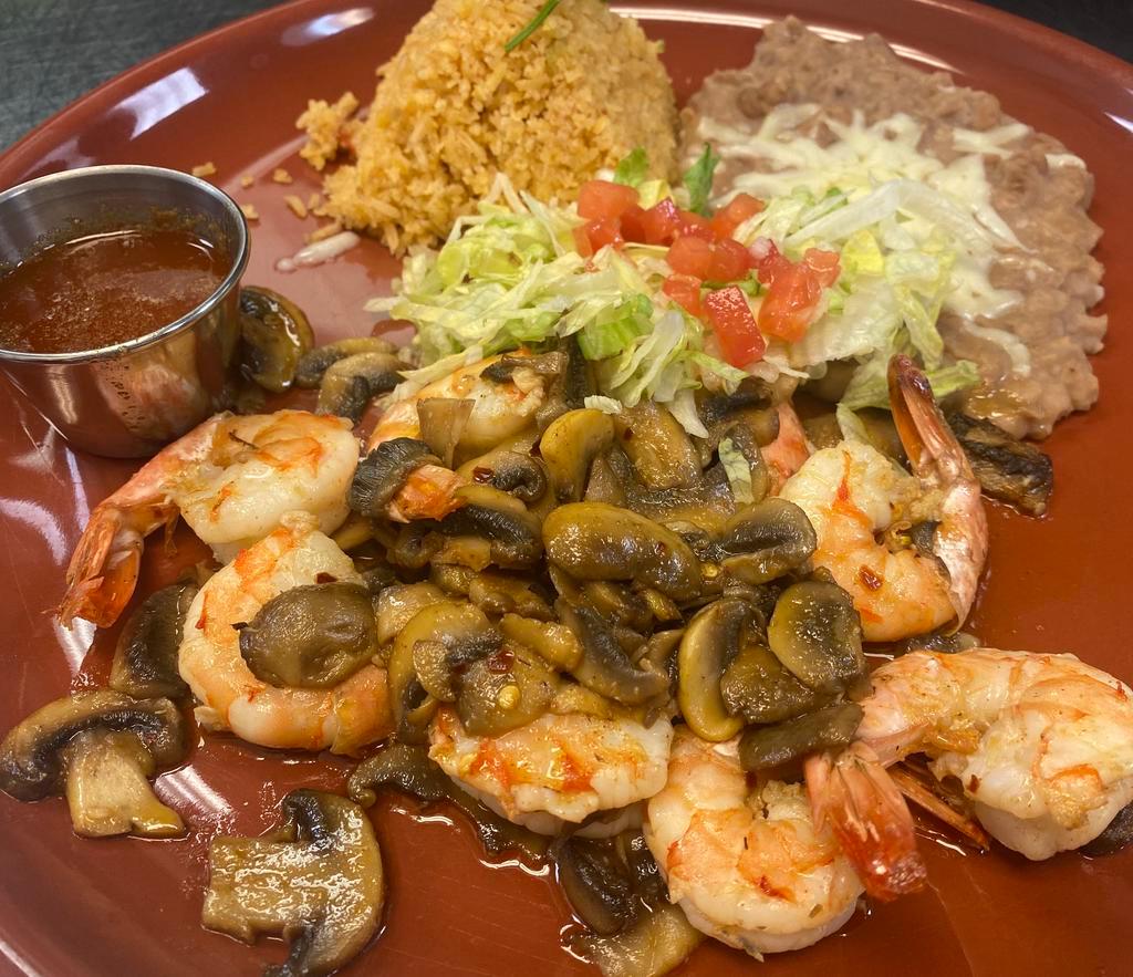 Camarones Al Mojo de Ajo · Large shrimp sauteed in garlic sauce, cooked with fresh mushrooms and served with rice and beans. Gluten free.