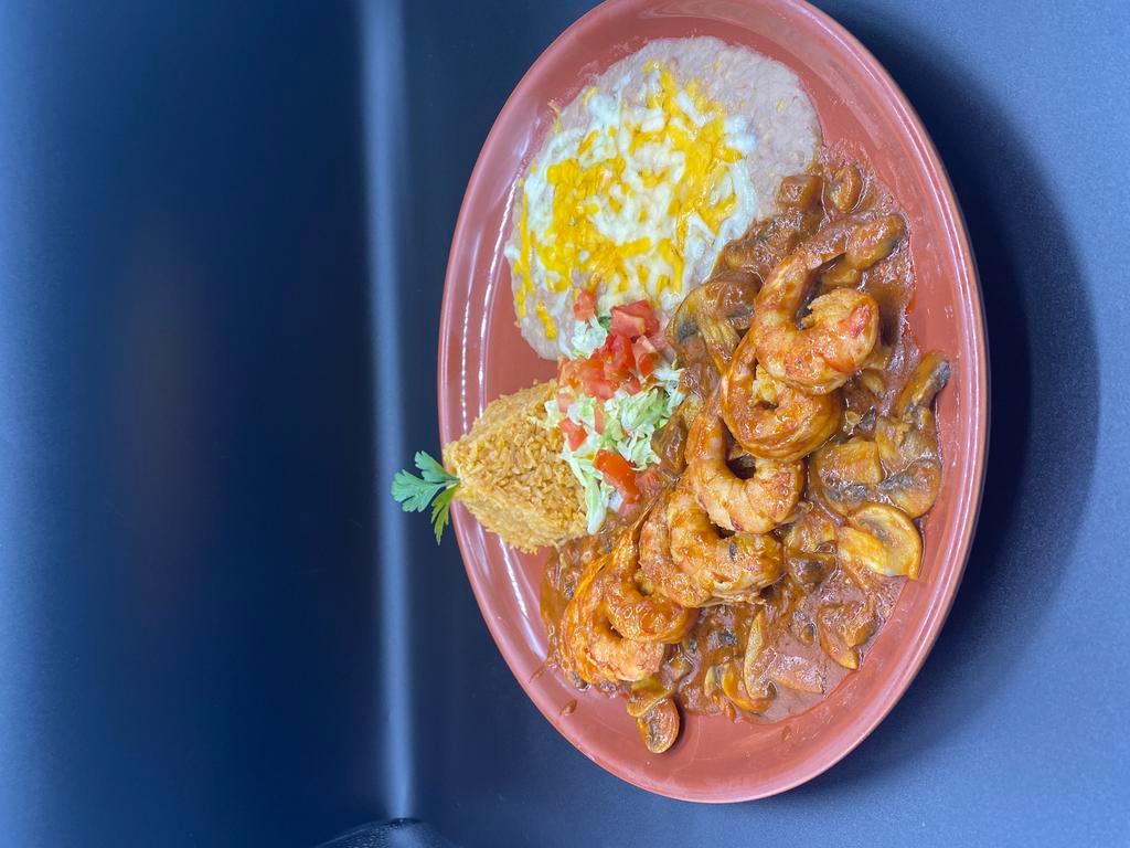 Camarones a La Diabla · House specialty. Shrimp sauteed with garlic, butter, mushrooms and spices. Covered with special mojo de ajo sauce and served with rice and beans. Mexican style. Spicy.