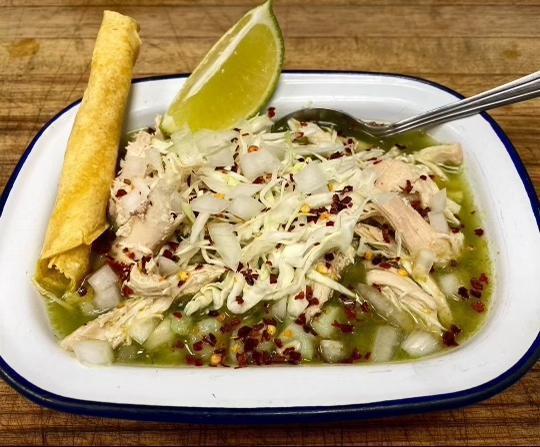 Pozole Verde con Pollo · Housemade chicken pozole verde with hominy. Served with cabbage, oregano, red chile flakes, and corn tortillas.