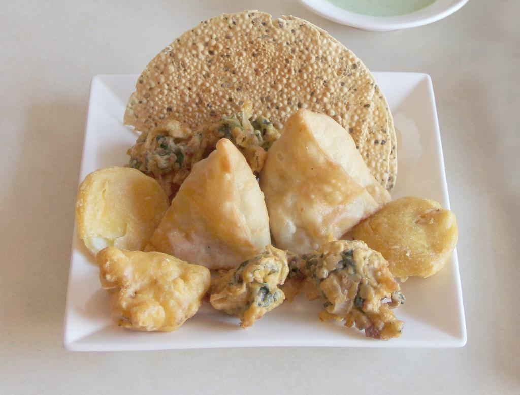 Mixed Appetizer for 2 · A combination of vegetable samosas, pakoras and papadam.