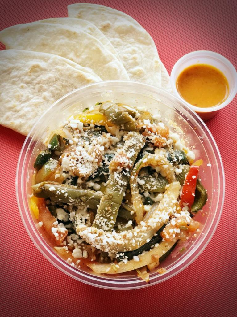 Nopales Salad (Cactus) · Slow cooked cactus grilled with tomatoes, poblano peppers, bell peppers, jalapenos, onions and cilantro topped with cotija cheese and served with our home-made flour tortillas.