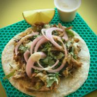 Carnitas Taco · Slow cooked pork shoulder, pickled red onions, cilantro and limes topped with tomatillo sauc...