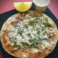 Panela Taco · Grilled queso blanco and refried pinto beans. Topped with cilantro, cotija cheese and roaste...