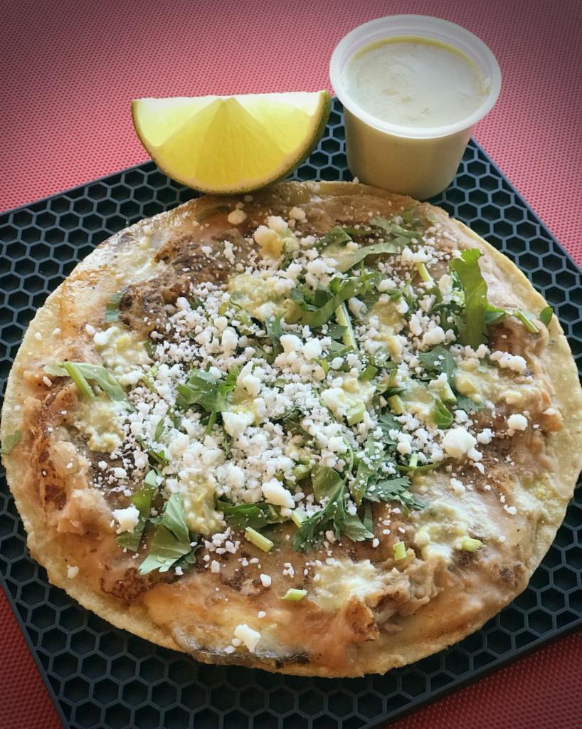 Panela Taco · Grilled queso blanco and refried pinto beans. Topped with cilantro, cotija cheese and roasted salsa verde. Served on a home-made corn or flour tortilla.