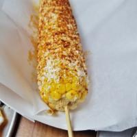 Elote Loco · Corn on the cob lightly coated with mayo, covered with Cotija cheese and dusted with chili p...