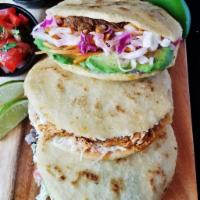 Arepas Tradicional · Venezuelan style white maize cake filled with shredded chicken, diced tomato, onion, cheese ...