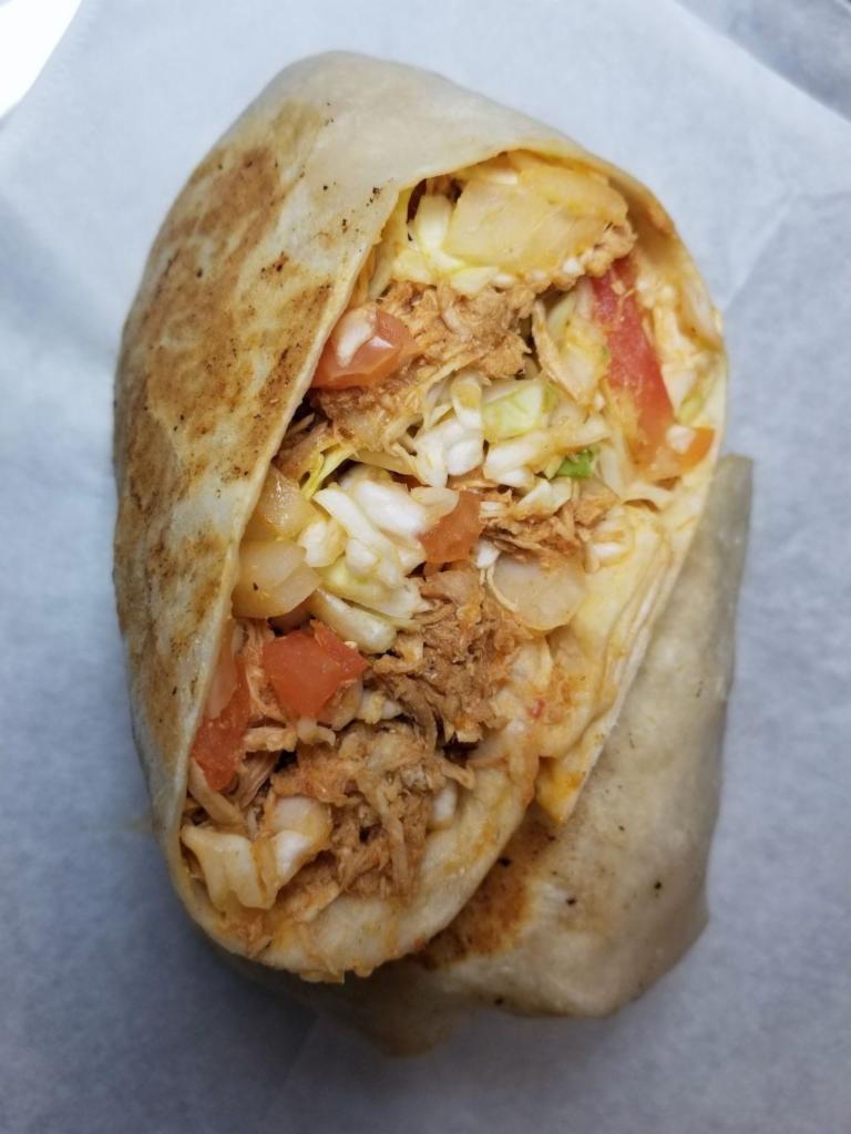El Dominicano Burrito · Flat grilled burrito filled with shredded chicken, sauteed cabbage, onion and tomato, finished with rosada sauce.