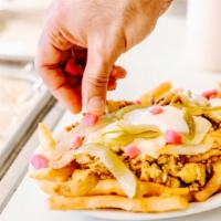 19. Beef Shawarma Fries · Treat yourself with our seasoned french fries topped with beef shawarma and served with melt...