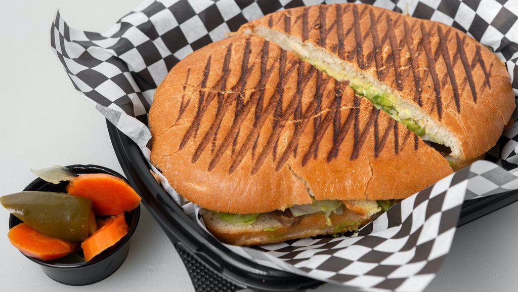 Torta Cubana · Ham, cheese, beans, lettuce, tomato, onion, jalapeno. Topped with avocado and our special dressing.
( please choose meat)