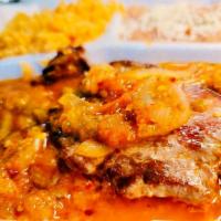 Bistec Ranchero · Rib-eye steak topped mexican sauce (Rice and beans).