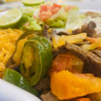 Bistec a la Mexicana · Rib-eye steak with onion, pepper, and tomato (Rice, beans and Salad).