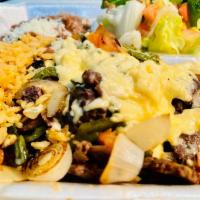 Bistec con Queso Fundido · Rib-eye steak with poblano pepper, tomatoes, onions and cheese on top (Rice, beans and Salad).