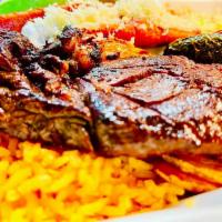 Carne a la Tampiquena · Grilled skirt steak IBP No.1 with cheese enchilada (Rice, beans, potato, grilled pepper, gri...