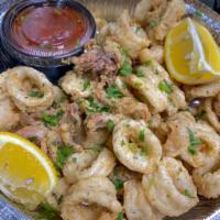 Calamares Fritos · Calamari tossed in cornmeal deep-fried to golden crispy with parsley and tomato sauce on the...